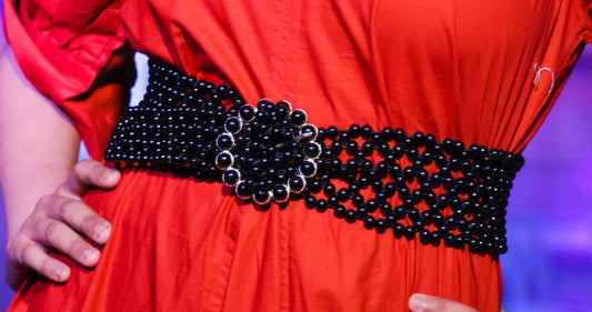 Broad pearl belt on red dress